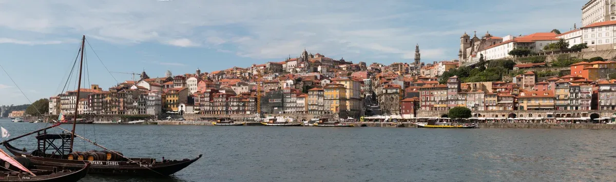 Rabelo boats on the Douro with the Ribeira panorama on the Porto bank, seen on a port wine cellar tour in Vila Nova de Gaia